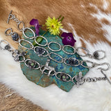 Hammered ovals with Succulent blooms. Hand cast sterling silver bracelet